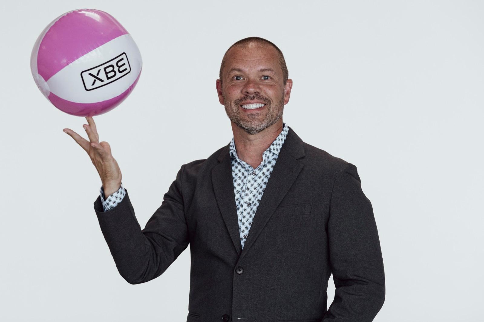 Sean Devine holding an XBE beach ball at Horizon Live 2026